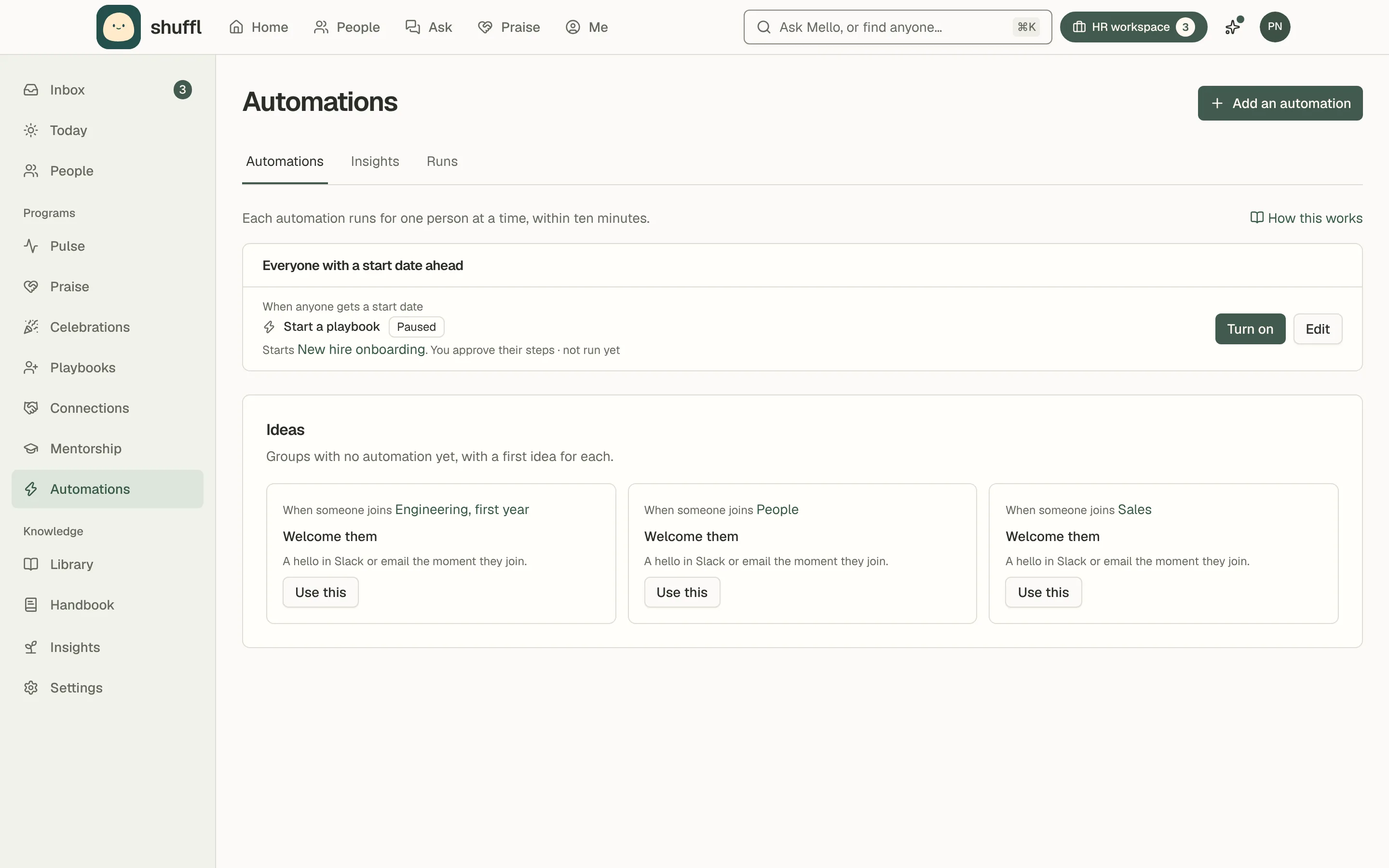 Automations under Programs: an Add an automation button, a card for Everyone with a start date ahead holding When anyone gets a start date, Start a playbook, Paused, Starts New hire onboarding, with Turn on and Edit buttons, and Ideas below for groups with no automation yet.